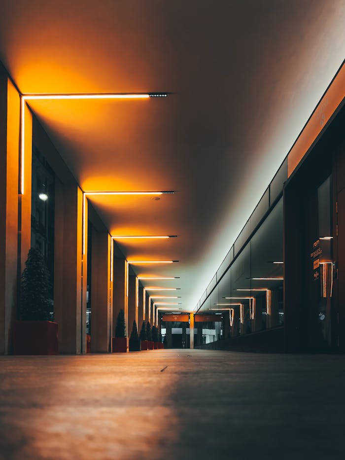 Symmetrical corridor with LED lights in Geneva, showcasing modern architecture and ambient lighting.